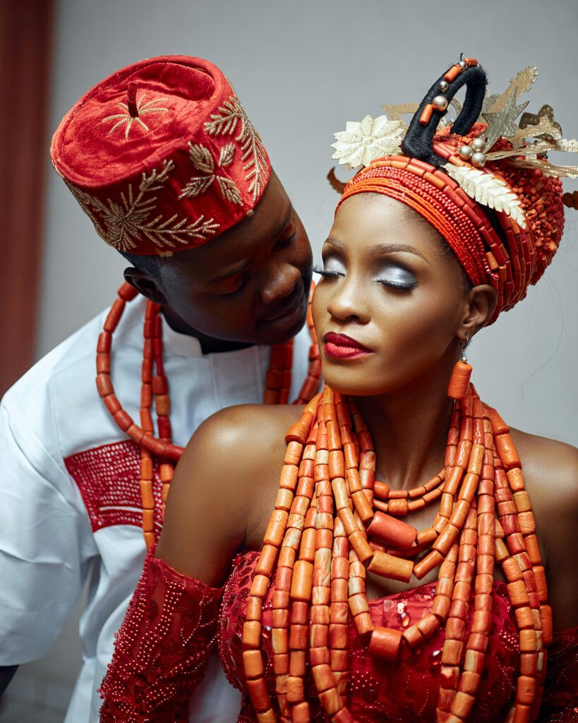 Elegant couple in traditional African wedding attire showcasing cultural heritage.